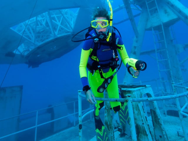 Diver Jaclyn Skafas explores the superstructure of the Gen. Hoyt S. Vandenberg artificial reef in the Florida Keys National Marine Sanctuary off Key West, Fla. Friday, May 29, 2009. After a dramatic May 27 scuttling, the Vandenberg opened to the public Saturday, May 30. The hull of the vessel rests on the sandy bottom in about 145 feet of water, but the 523-foot-long former U.S. Air Force missile tracking ship is so massive that its superstructure begins just 45 feet below the sea surface. (Stephen Frink/Florida Keys News Bureau/HO)